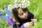 Beautiful teenager counting petals in grass