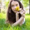 Beautiful teenager with dandelion bouquet