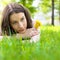 Beautiful teenager with dandelion bouquet