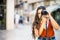 Beautiful teenager focused on taking photography in urban scenic