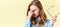 Beautiful teenager girl with ginger hair and freckles holding reading glasses, having headache and sore eyes.