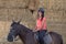 Beautiful teenager with his horse learning to ride