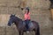 Beautiful teenager with his horse learning to ride