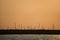 Beautiful telephoto view of many construction cranes during epic orange sunset over Dublin seen from west pier of Dun Laoghaire