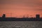 Beautiful telephoto view of many construction cranes during epic red sunset over Dublin seen from west pier of Dun Laoghaire