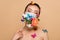 Beautiful tender naked asian girl with closed eyes in floral face mask with butterflies