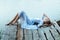 Beautiful tender woman lying on the jetty and bored.