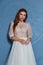 Beautiful tender young woman sexy brunette bride in a luxury white wedding dress lace chiffon Summer happiness awaits the groom