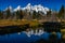 The Beautiful Tetons Covered in Snow Reflecting on a Calm River