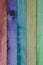 Beautiful texture of colorful natural wood slats rainbow, red, purple, turquoise blue, yellow and green.