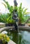 A beautiful Thai-style fairy statue standing in a pool of home g