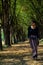 Beautiful Thai woman walking around in tunnel of tamarind trees, look smart.