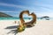 Beautiful Thailand travel island Koh Lipe white sand beach with heart bamboo sculpture landmark and blue sky landscape background