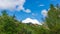 Beautiful thick clouds over big crag in the blue sky