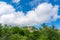 Beautiful thick clouds over rocky mountain peak in the blue sky