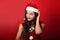 Beautiful thinking grimacing woman in santa claus christmas cost
