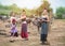 Beautiful Three Asian women dressed in Traditional costume with buffalo at farmland,one in front hold old radio in hand,one hand