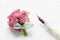 Beautiful tiny bouquet of pink kalanchoe blossfeldiana flowers and vintage sheet of paper