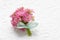 Beautiful tiny bouquet of pink kalanchoe blossfeldiana flowers and vintage sheet of paper