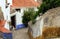 Beautiful tiny cobblestoned street, walls, and roofs in Obidos, Portugal