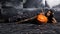 Beautiful tired miner worker sitting on a floor on steel background, pickaxe and orange helmet lies nearby