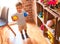 Beautiful toddler boy playing with colored small balls at kindergarten