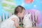 Beautiful toddler kissing bunny at easter time