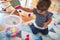 Beautiful toddler saving blocks in plastic cube at kindergarten