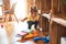 Beautiful toddler taking books of shelving at kindergarten