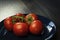 Beautiful tomatoes on a wooden background