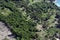 Beautiful top view of the Dominican National Park: trees, shacks, roads and areas of felled trees.