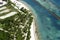 Beautiful top view: turquoise Caribbean Sea, sandy beach, palm grove, hotels on a bright sunny day.
