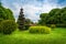 Beautiful topiary art in park design. Trimmed trees and shrubs in a summer city park. Evergreen landscape park