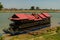 Beautiful tour boat adorned with flowers and with intricate roof moored on the bank of Mekong River