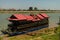 Beautiful tour boat adorned with flowers and with intricate roof moored on the bank of Mekong River