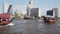 A beautiful tourist boat floats along the main river of the capital of Thailand - Chao Phraya against the background of tall skysc