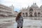 Beautiful tourist girl with long wavy hair in Piazza San Marco i