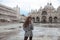 Beautiful tourist girl with long wavy hair in Piazza San Marco i