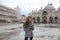 Beautiful tourist girl with long wavy hair in San Marco square i