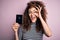 Beautiful tourist woman with curly hair and piercing holding australia australian passport id with happy face smiling doing ok