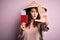 Beautiful tourist woman with curly hair and piercing wearing asian hat holding japan passport with open hand doing stop sign with