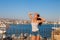 Beautiful tourist woman on the old castle on Mediterranean sea coast. Paphos, Cyprus. Bright sunset light