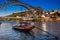 Beautiful traditional boat and the Dom Luis I Bridge a metal arch bridge over the Douro River between the cities of Porto and Vila