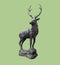 Beautiful and traditional british Deer Stag bronze, or alloy statue or sculpture cut out against a pale green background