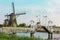 Beautiful traditional dutch windmills near the water channels with drawbridge