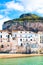 Beautiful traditional houses on the coast of Tyrrhenian sea in Cefalu, Sicily, Italy. Behind the buildings magnificent rock