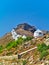 Beautiful traditional white windmills on a hill in Leros island, Greece. Medieval castle of Panteli or Panteliou on hill top
