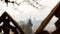 A beautiful traditional wooden church from Maramures, Romania, as seen through the crosses from a cemetery in the nearby village