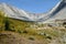 A beautiful trail above the treeline with a huge mountain in the background during a beautiful sunny day in autumn