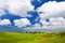 Beautiful tranquil view of Maui landscape with white clouds over green fields
